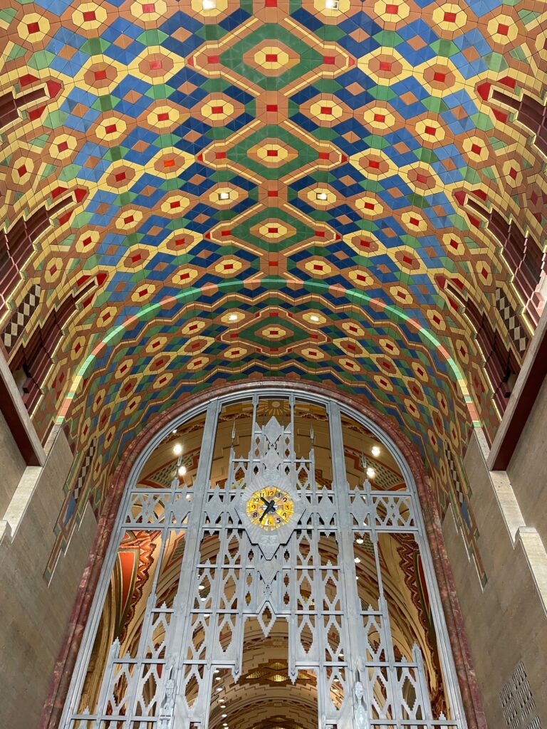 The yellow and orange mosaic tiled ceiling is stunning