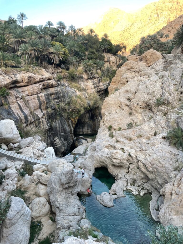 View froma bove onto natural water pools with stairs leading down to them.