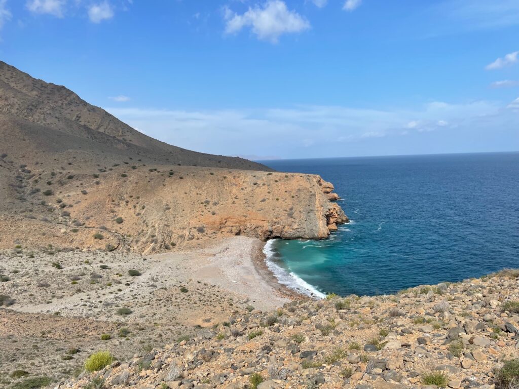 The coast features mountains in the background