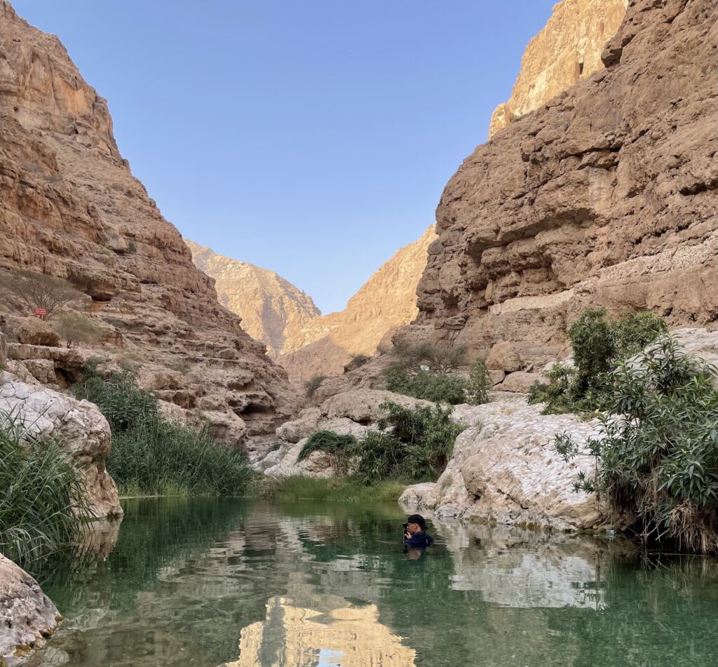 mountains, rocks, and a pool of water. 6 wadis to cool off in Oman