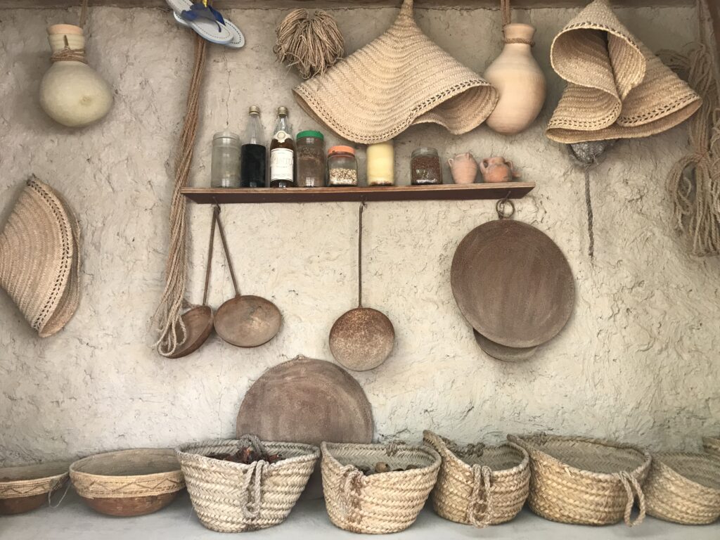 Wicker baskets and mats line up to re-create an Omani traditional kitchen