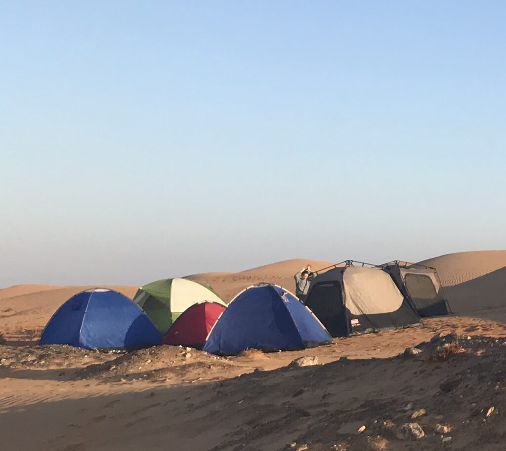 five tents are set up next to each other in the desert