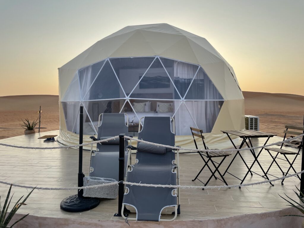 A dome tent includes a double bed, private bathroom and a deck