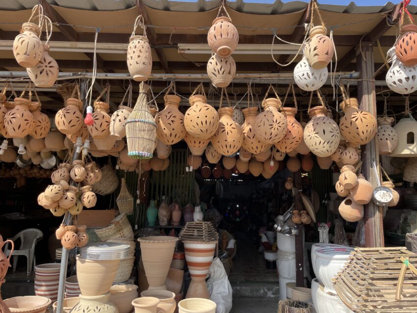 Hanging clay pottery includes water pitchers and vases