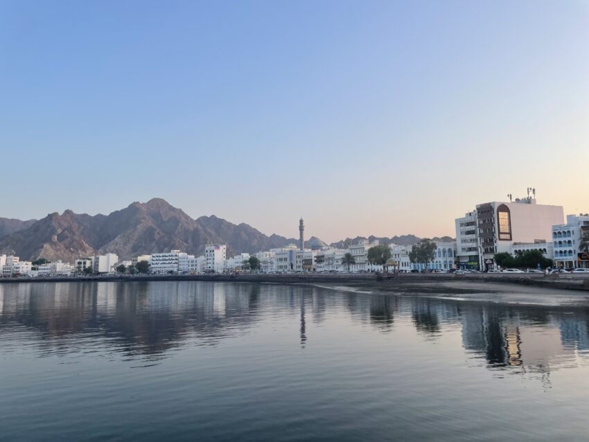 buildings along the corniche reflect in the water