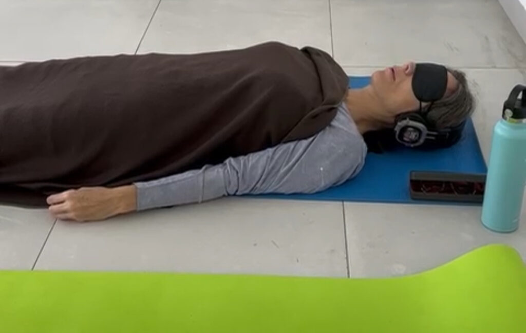Erin laying down listening to headphones